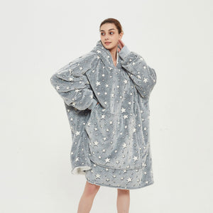 Snuggyz star glow-in-the-dark hoodie blanket draped over a sofa, showcasing its cozy, star-patterned design for comfortable lounging.