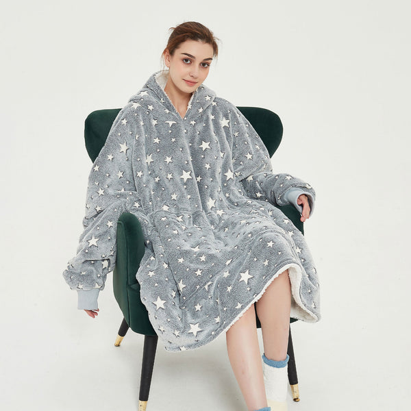 Snuggyz star glow-in-the-dark hoodie blanket showing a cozy hoodie with star patterns and glowing details in low light.